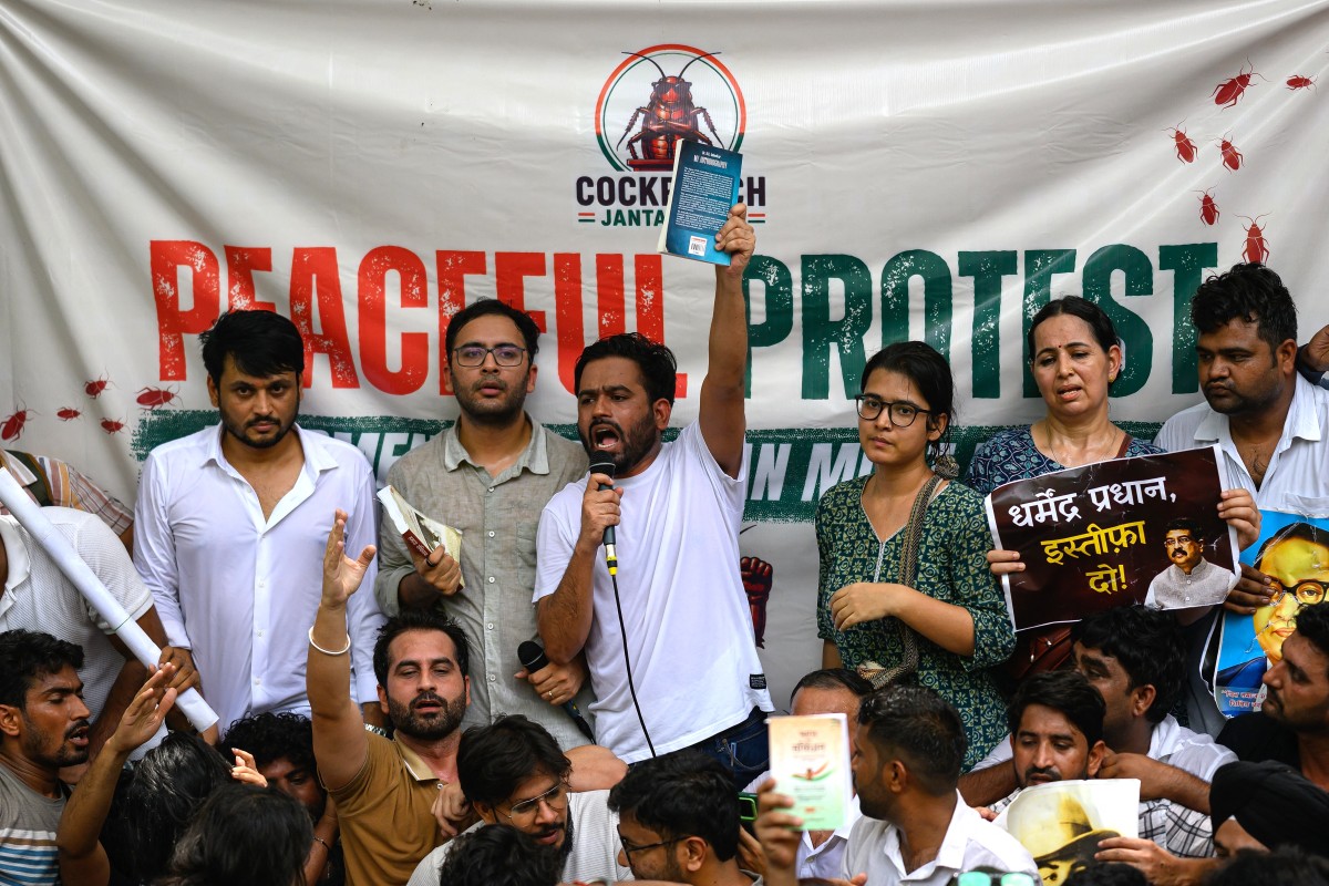 Cockroach Janta Party supporters at a protest in New Delhi, with the party's crest visible on the backdrop banner